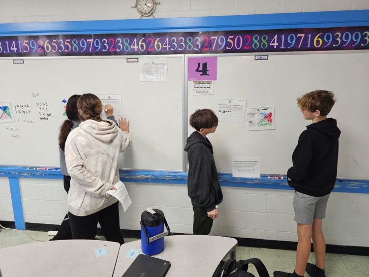 students at whiteboard 