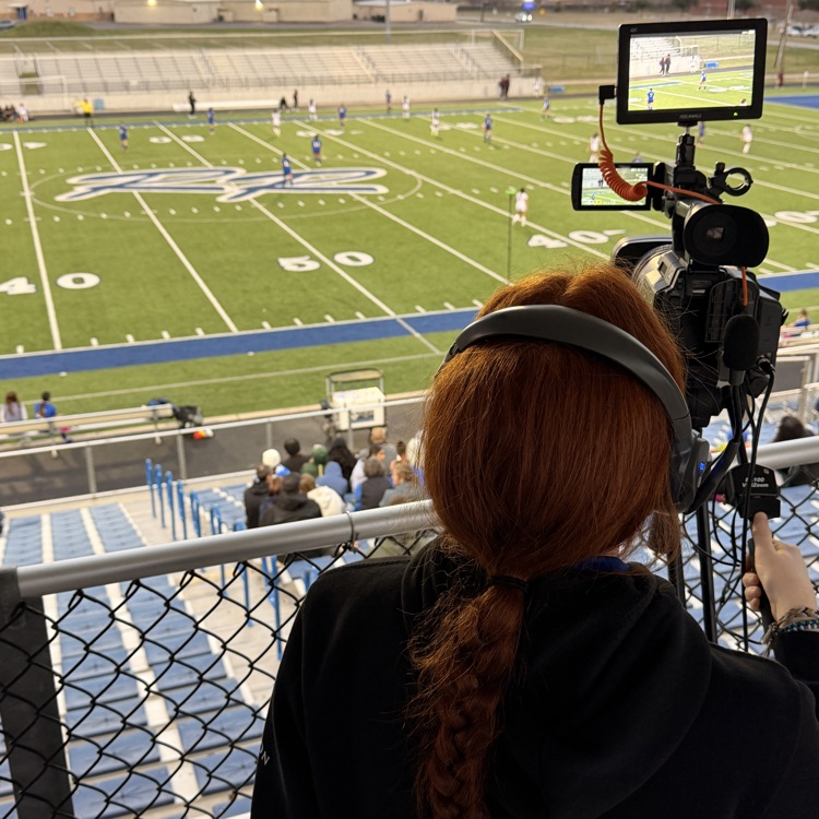 student filming a game