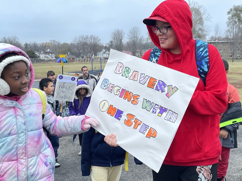 Students with sign that reads, "Bravery Begins with One Step"