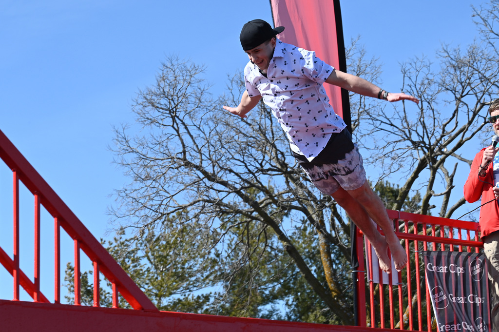 Student mid-air as they plunge in the pool.