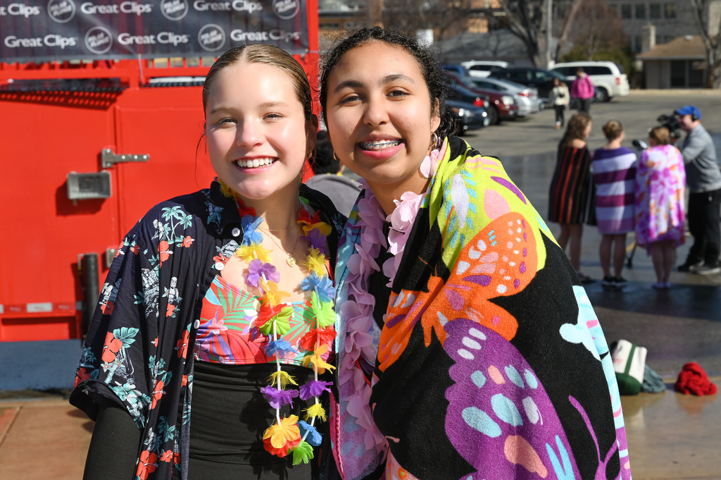 Two students posing for a photo after diving in the pool.