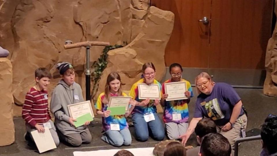 Longfellow students accepting a reward
