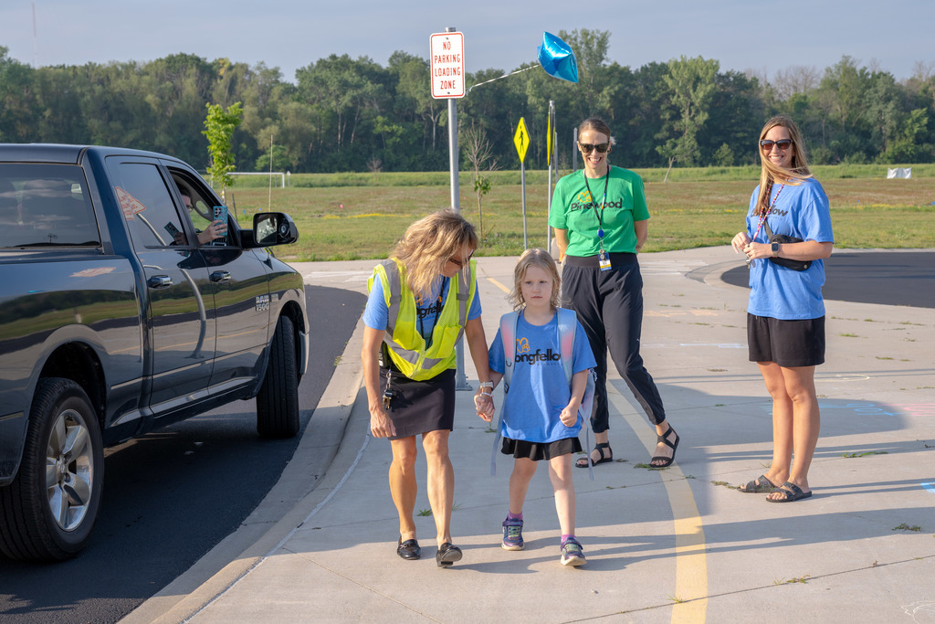 Principal Adams walking student into school
