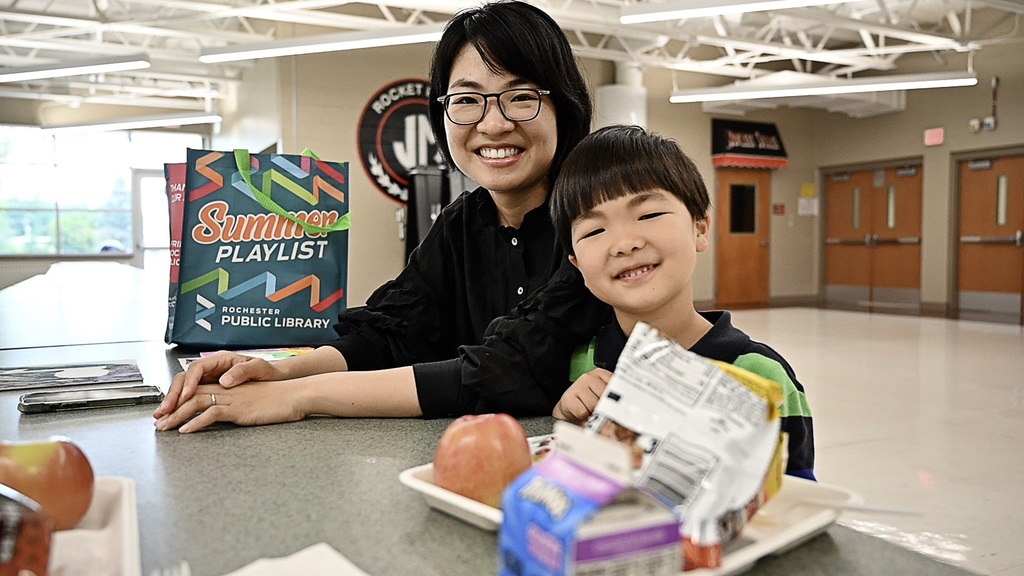 Family eating lunch at JM Cafeteria during summer meal times.