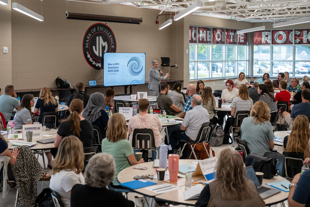 Superintendent Kent Pekel addresses new teachers in John Marshall High School Cafeteria.