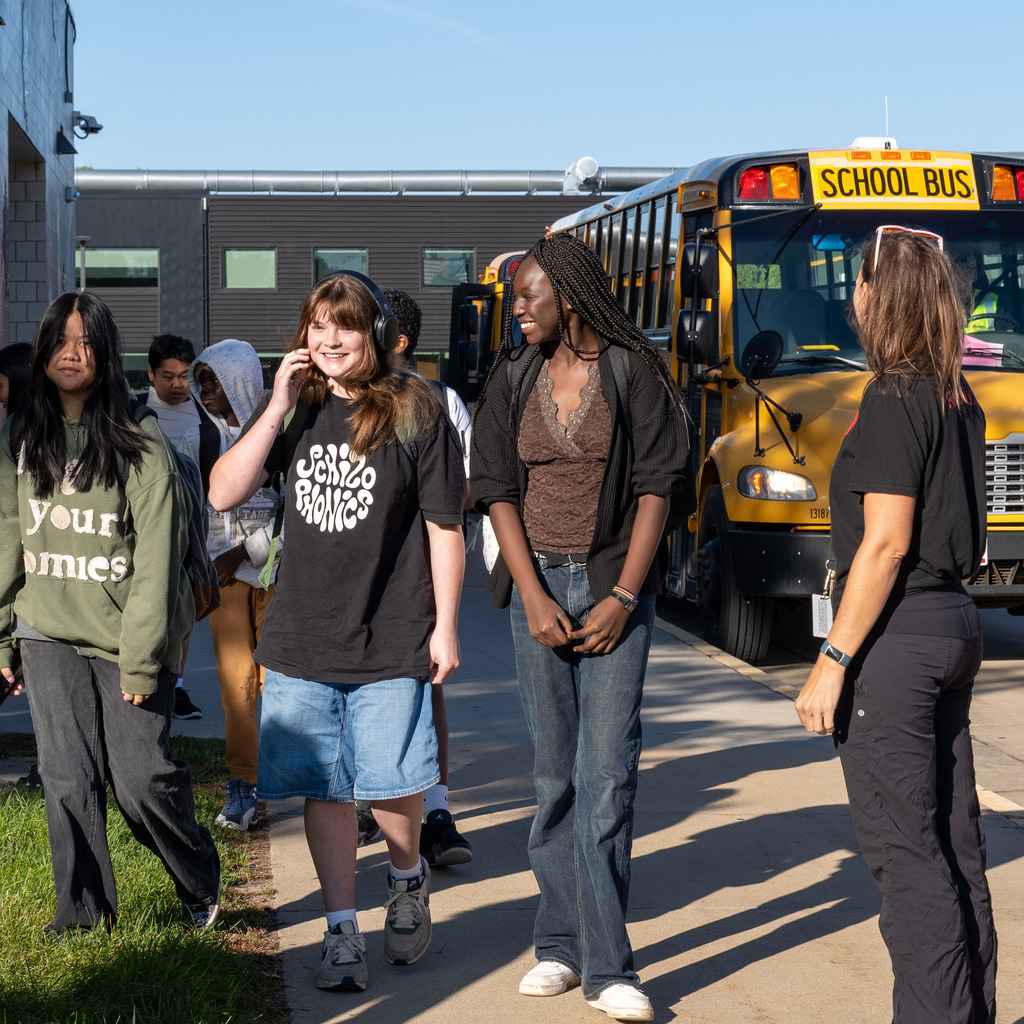 Students getting off the school bus for the first day of school.