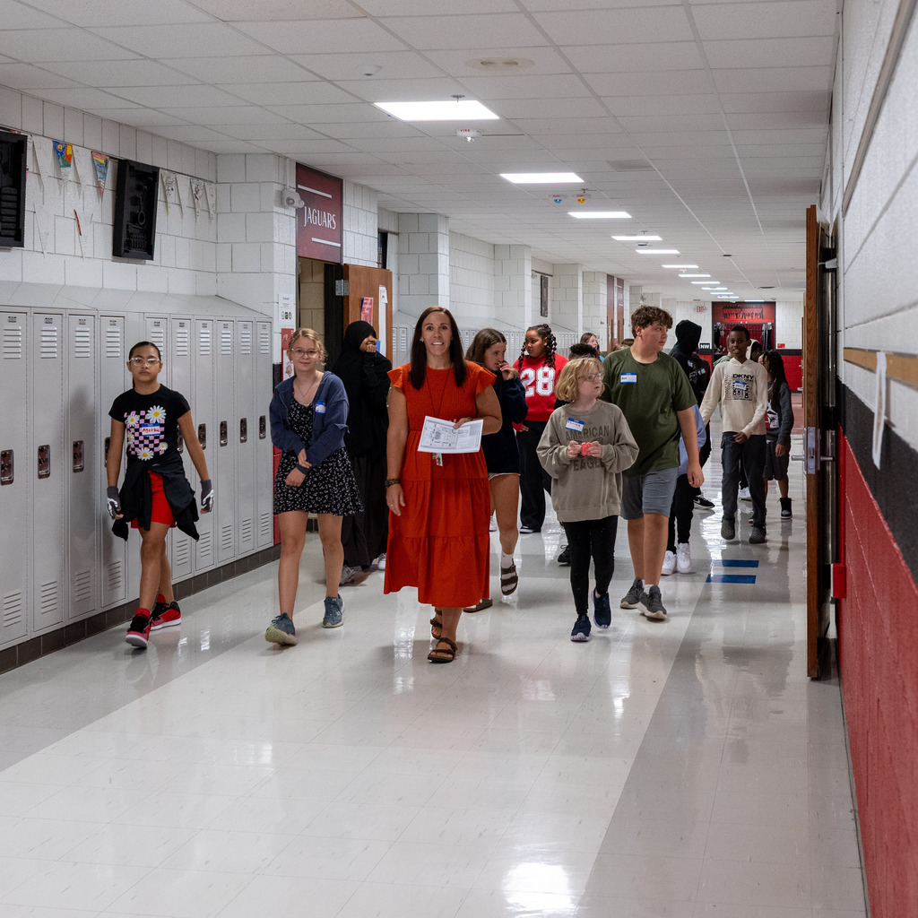 6th grade students walking the hall for a tour.