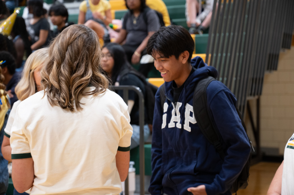 Mayo teacher helping student in the gym.