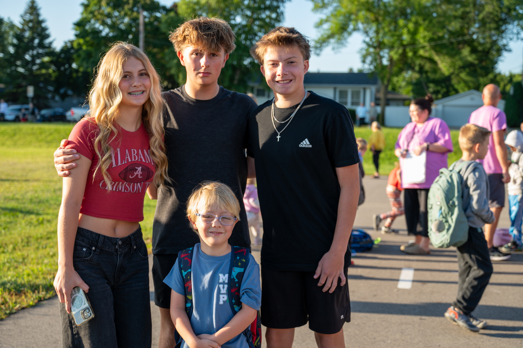 Siblings dropping off their youngest sibling at school