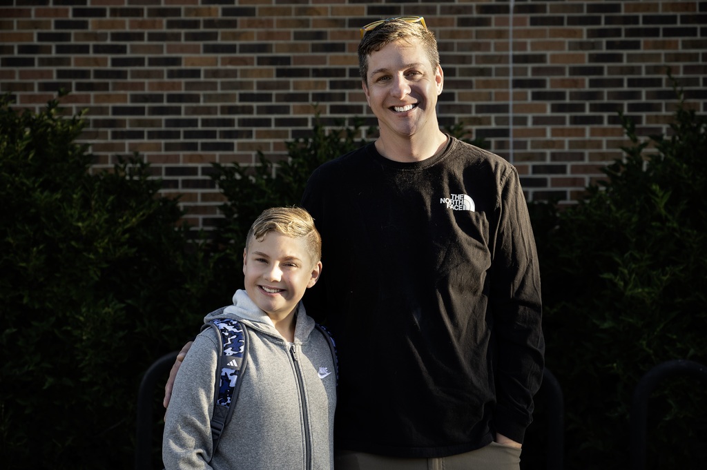 a parent and their child smilng at the camera