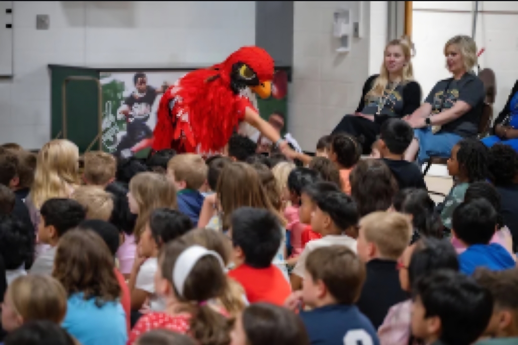 Our Falcon greeting kids at the assembly