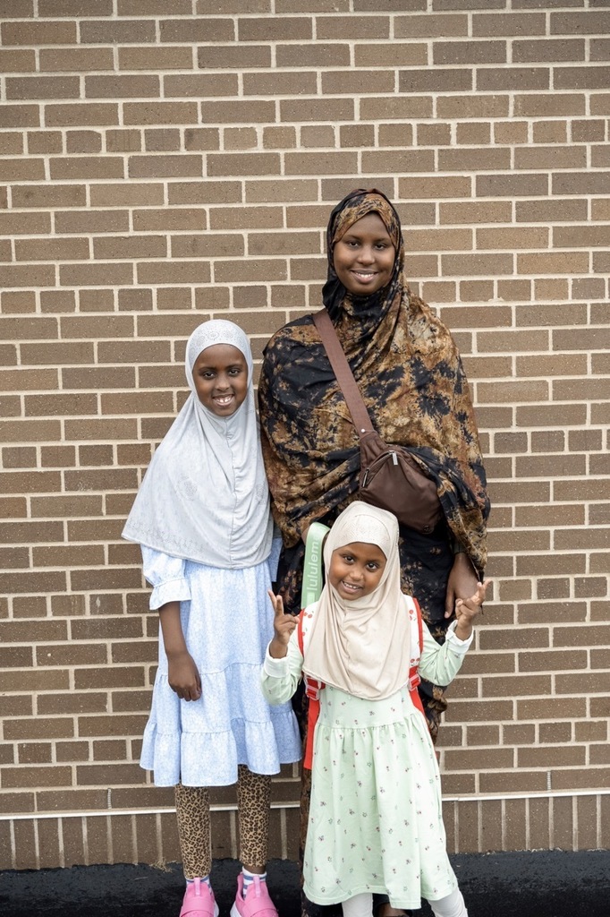 Family posing for the first day of preschool outside of Hoover.