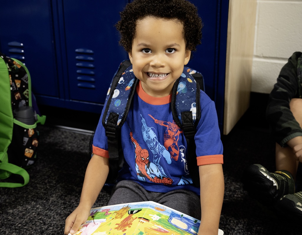 Student reading a book before class.