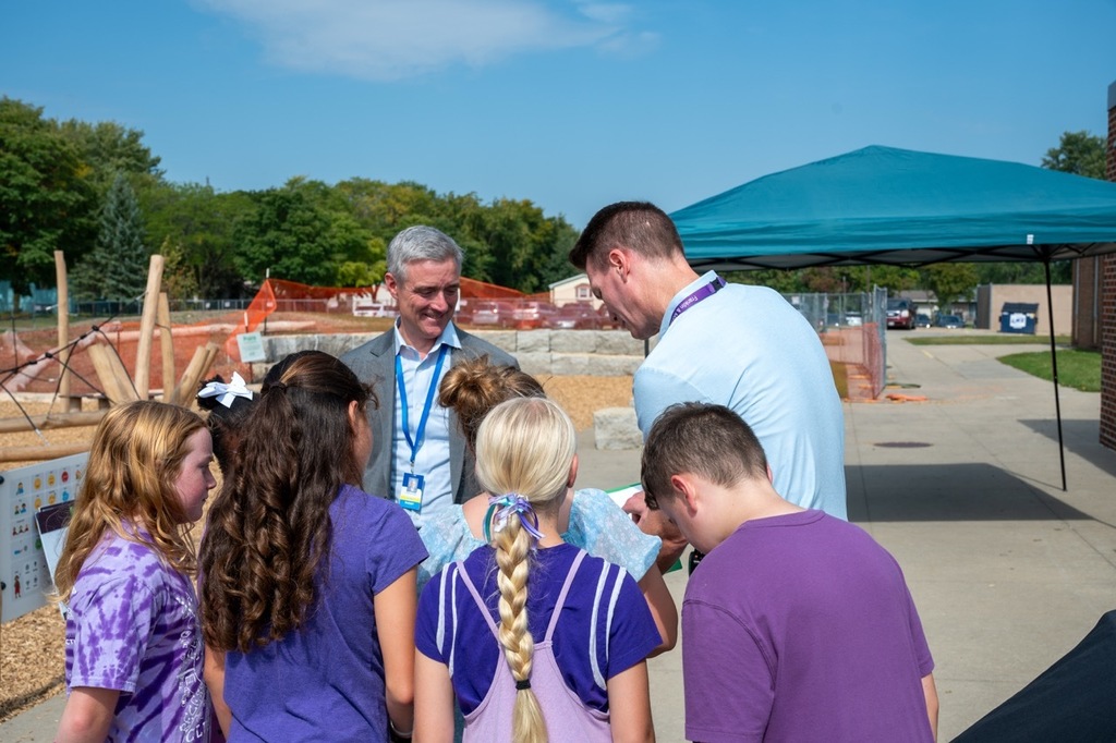 Superintendent Dr. Kent Pekel watches students enjoy the new park