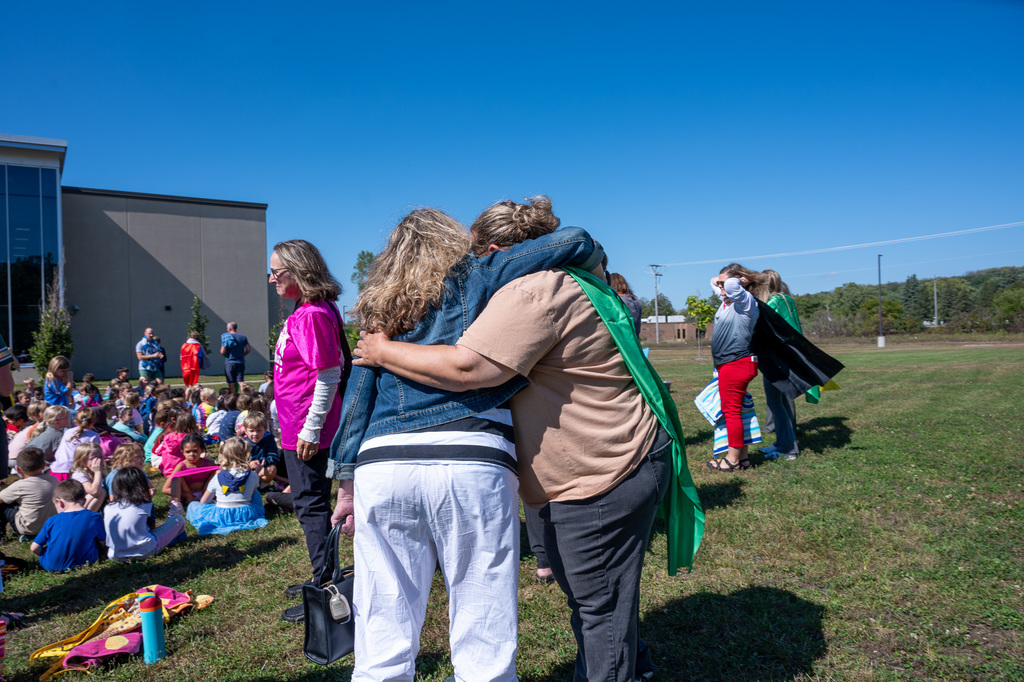 Longfellow teachers embrace each other before the festivities of the ice bucket challenge