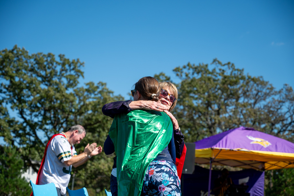 RPS school board member Jean Marvin gives a soggy embrace to Longfellow teacher 