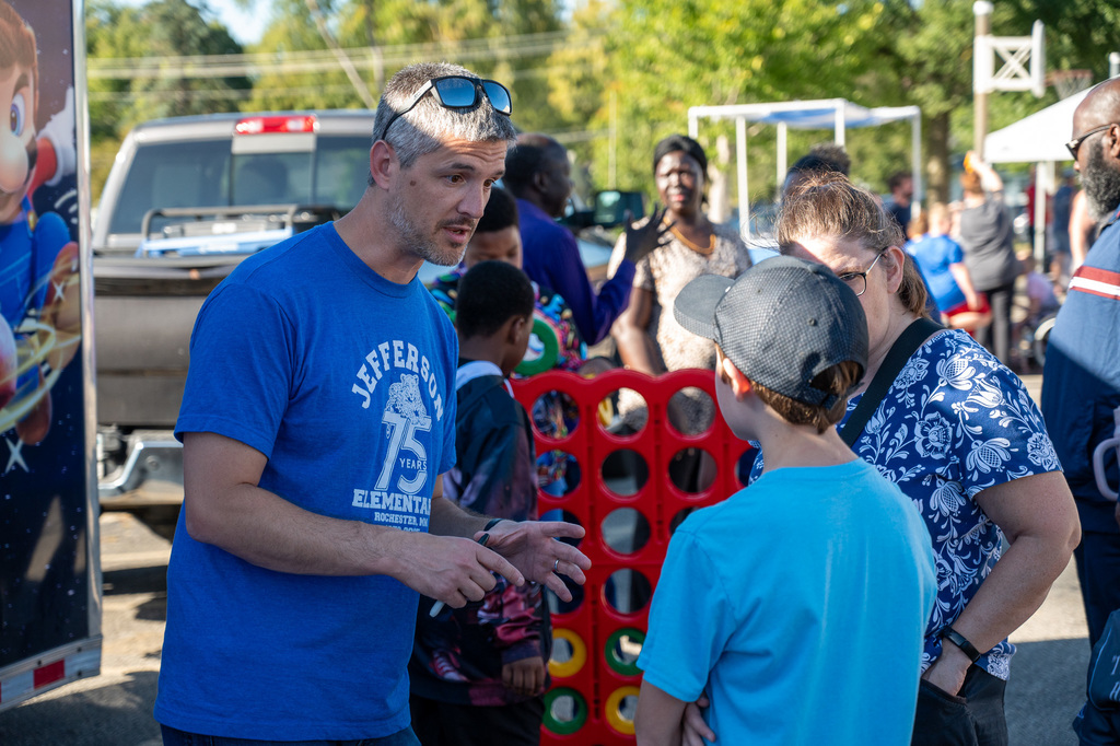 School board member Justin Cook speaks with a student about the RPS robotics program.