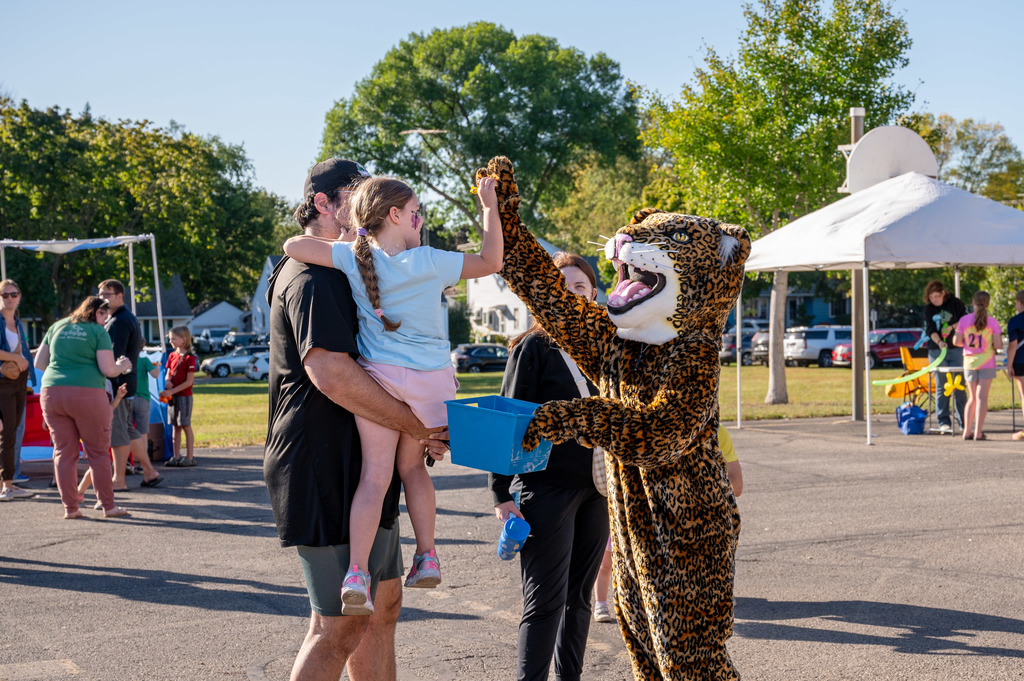 Jefferson jaguar high fives a child