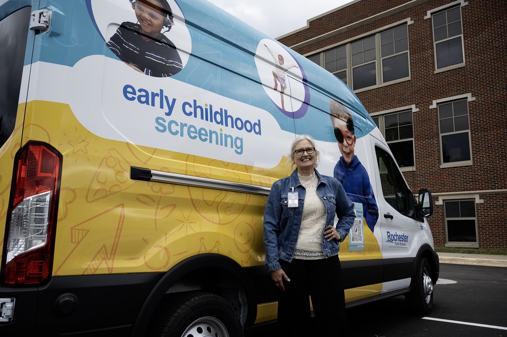Bobbi Tweed in front of the Early Childhood Screening Van at Northrop Community Education Center