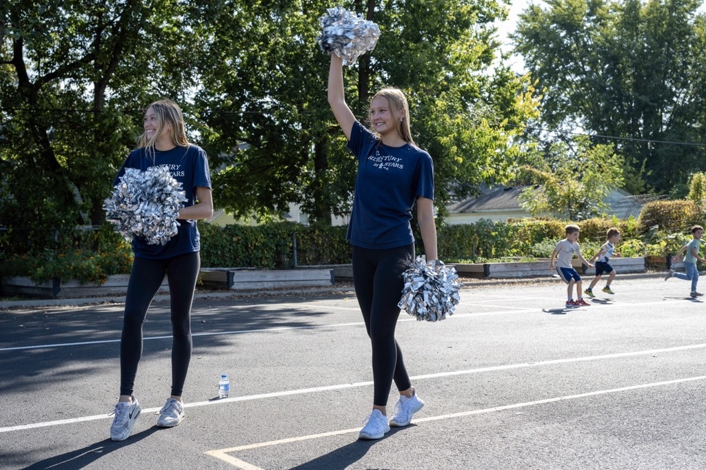 Century cheerleaders performing for students on the blacktop