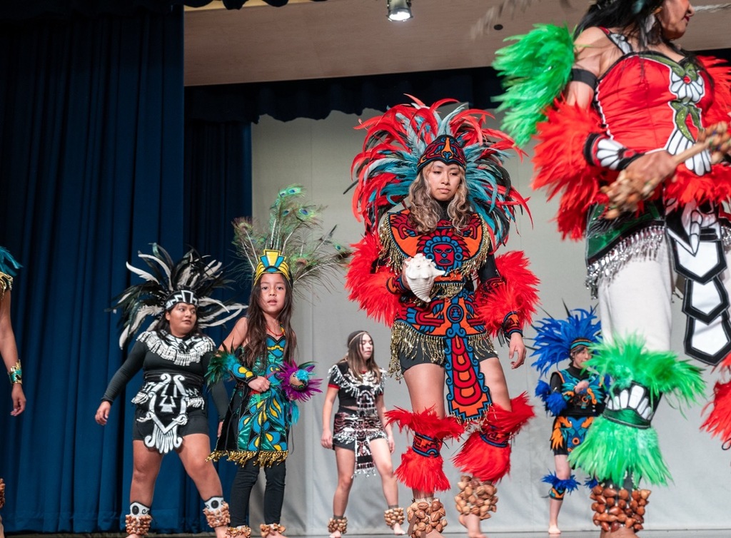 Aztec Dancers in a circle on stage