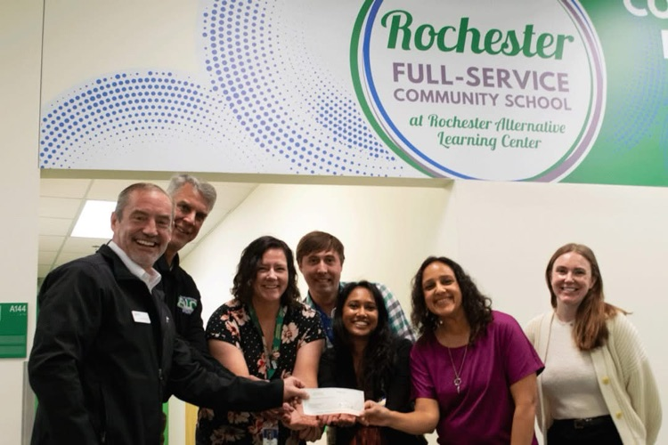 United Way presenting Rochester Public School representatives with a donation check.