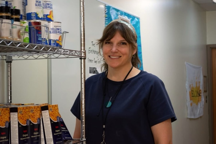 Lisa Becker standing in the Riverside Community School room.