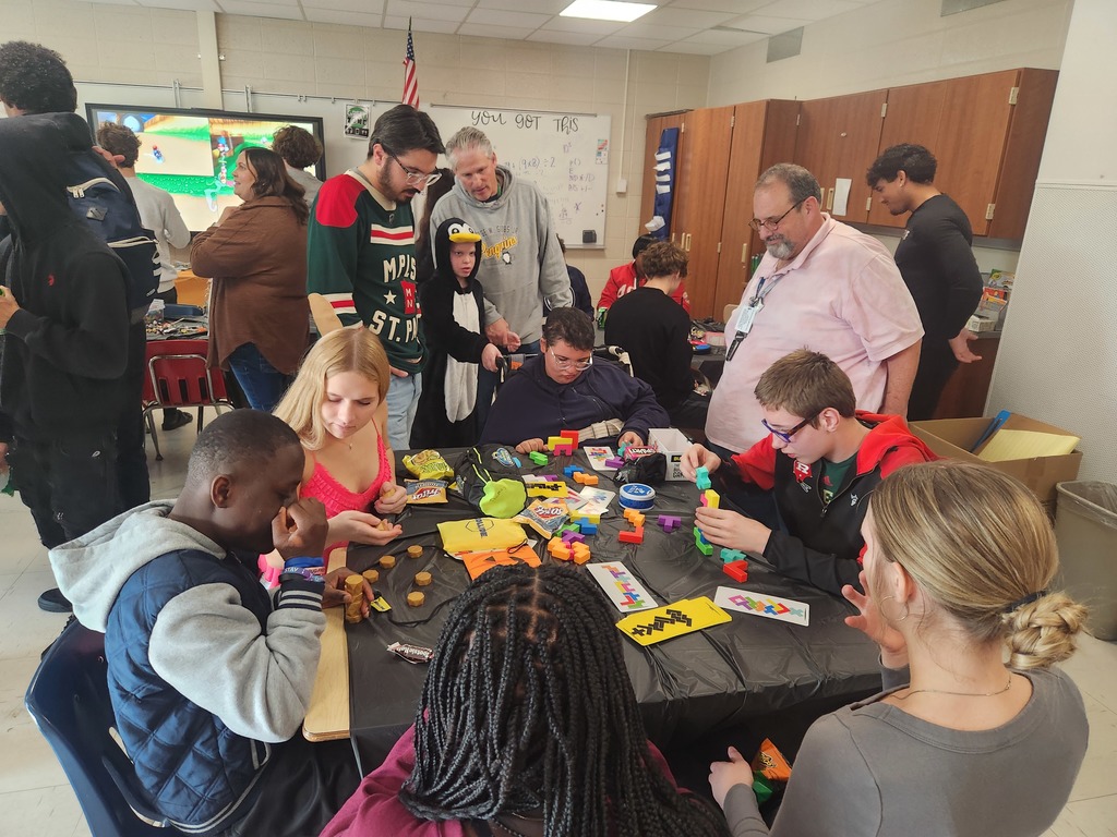 Picture of students and teachers gathered around a table making crafts