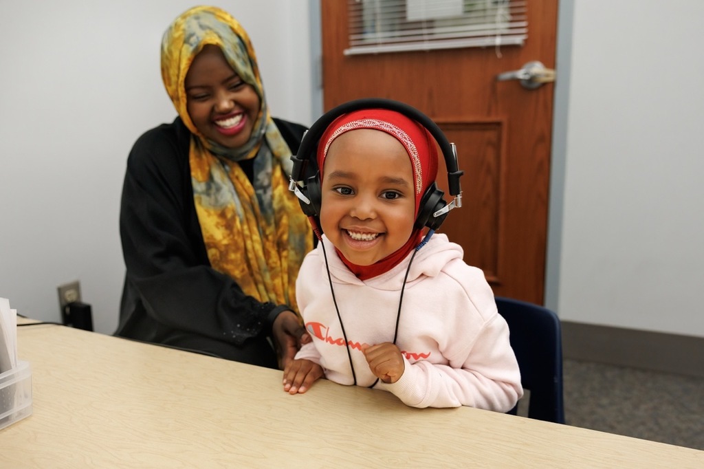 3 year old completing the hearing test during early child screening.