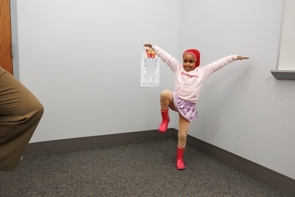 Student practicing their balance  on one leg in the room.