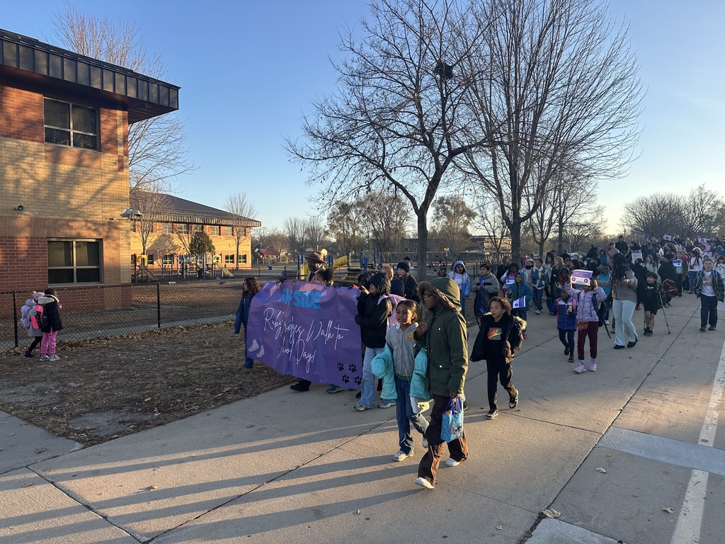 Line of people with purple banner in front