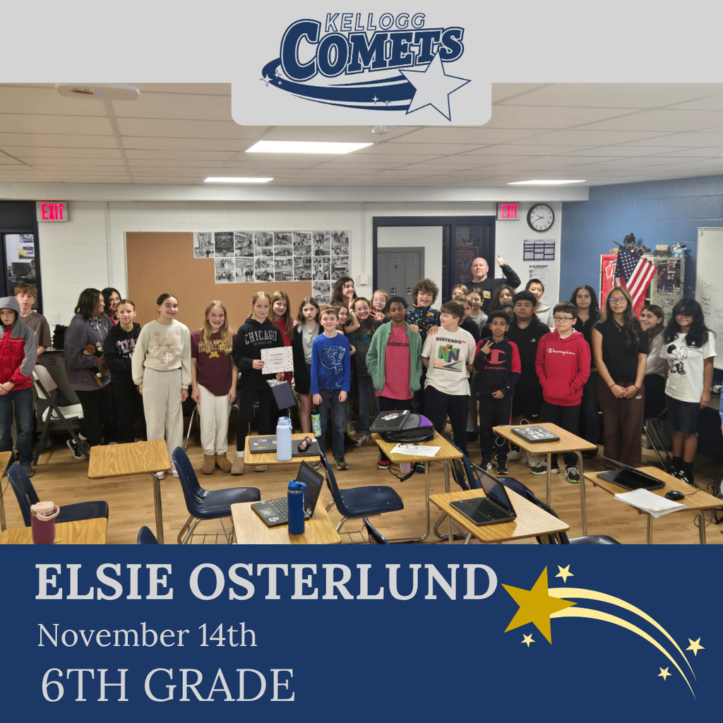 classroom of students in multicolored clothing, student in middle holding certificate for student of the week