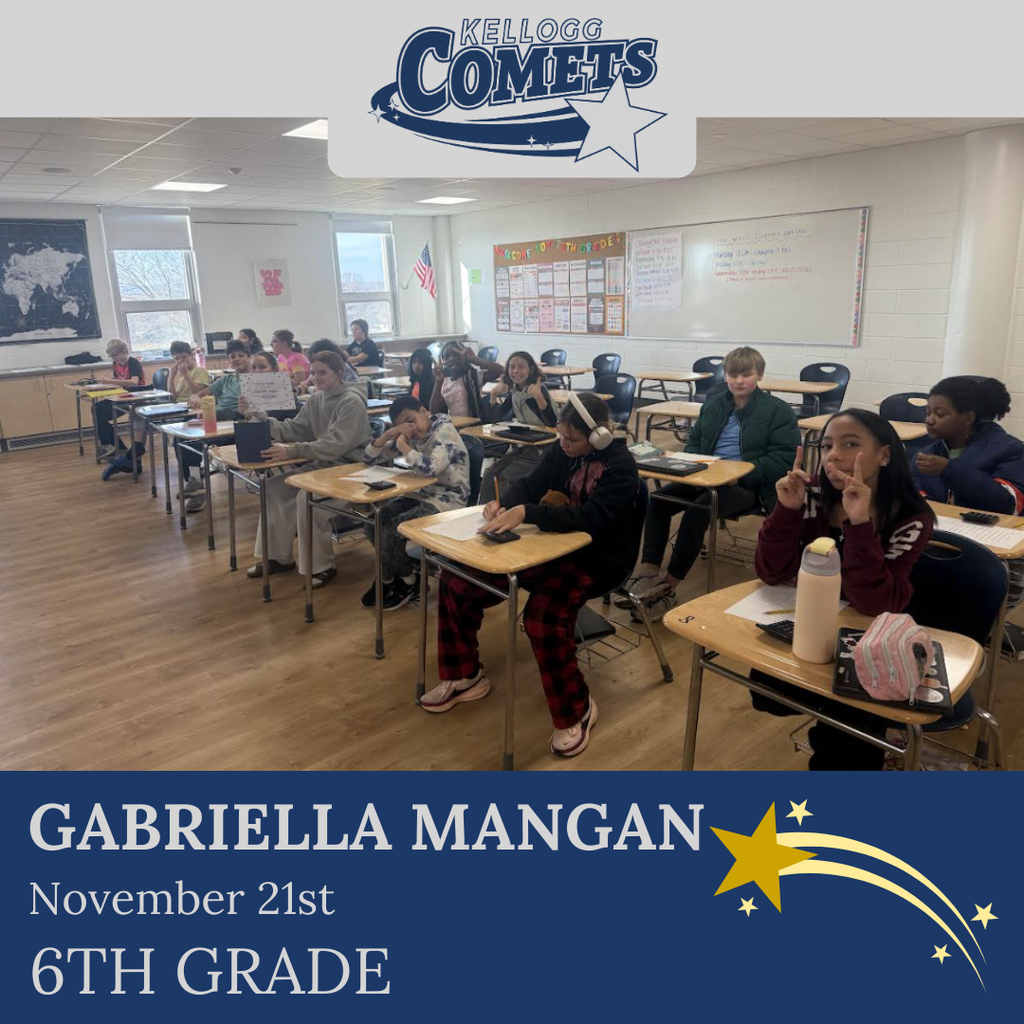classroom of students in multicolored clothing, student in middle holding certificate for student of the week