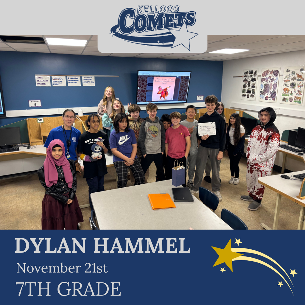 classroom of students in multicolored clothing, student in middle holding certificate for student of the week
