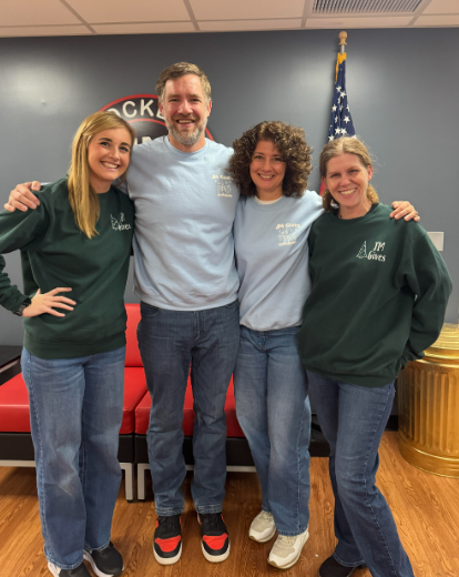 Staff wearing vintage JM Gives merch