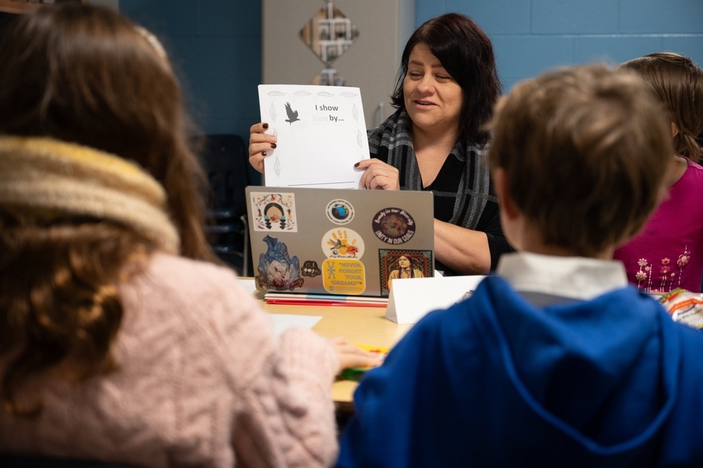 Students learning in a small group with American Indian Liaison, Jo.