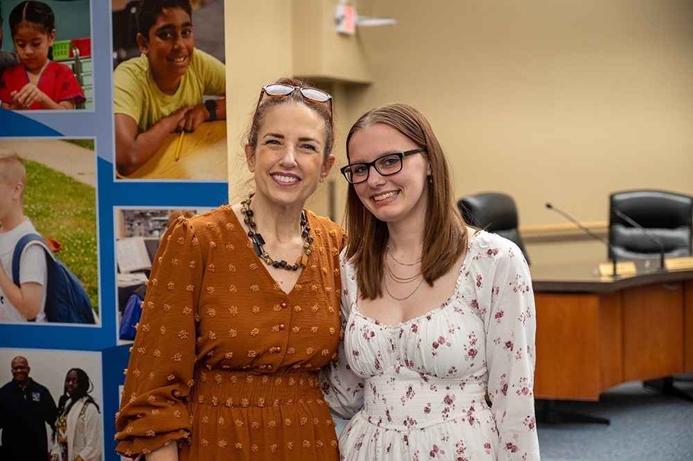 Family standing smiling at the camera for a picture