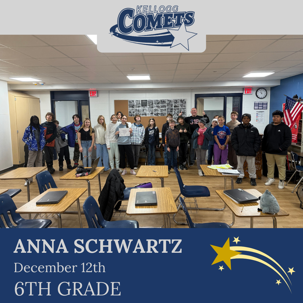 classroom of students in multicolored clothing, student in middle holding certificate for student of the week