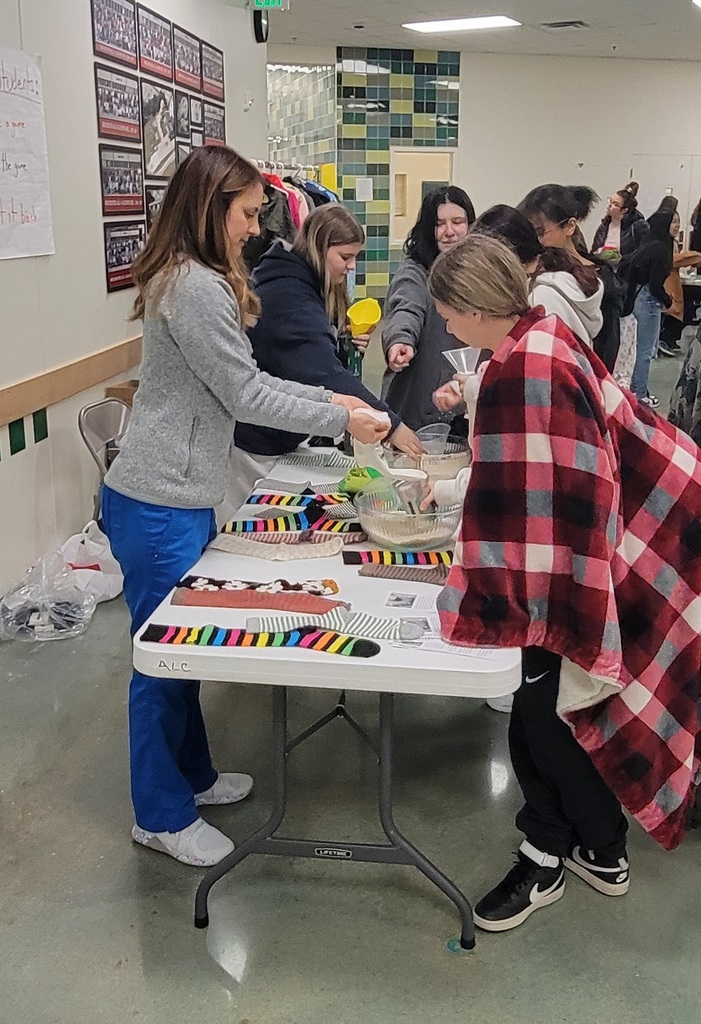 Students make DIY cold/heat packs out of rice and socks.