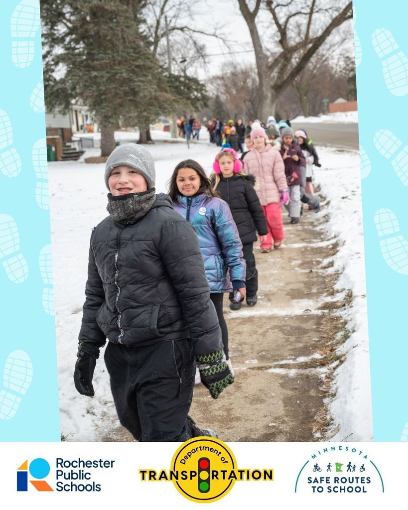 A line of children trail the sidewalk; the kid in a black jacket at the front smiles;  Rochester Public Schools logo; Department of Transportation; Minnesota Safe Routes to School