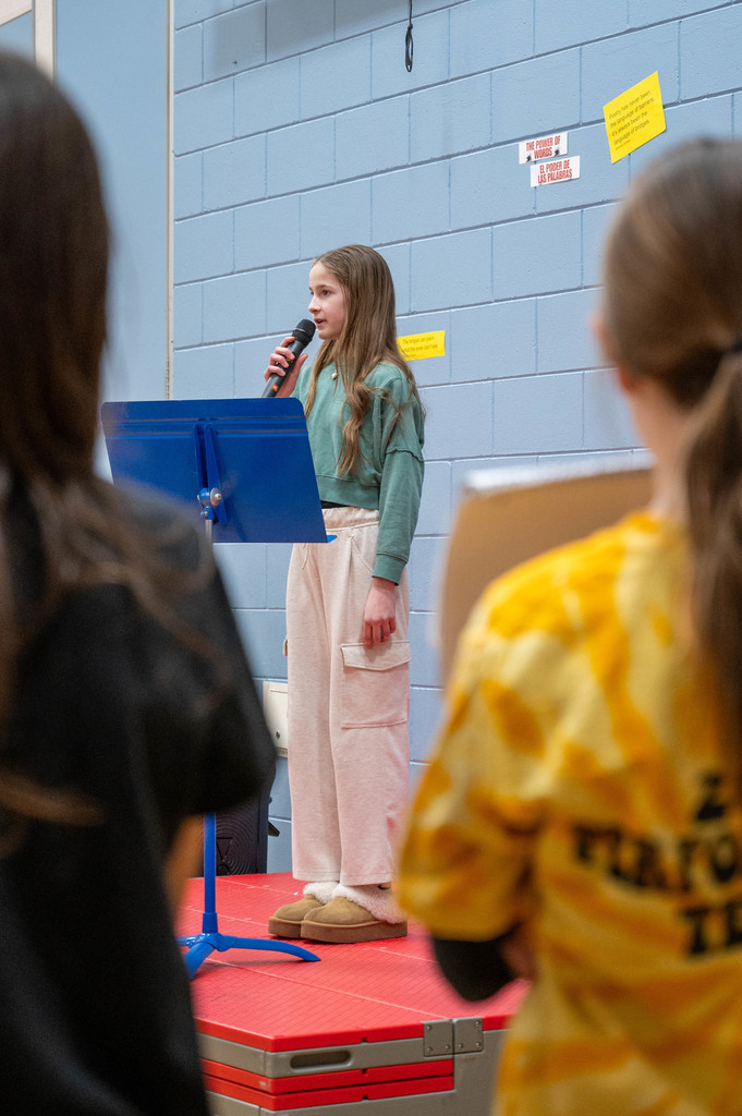 A Riverside student shares her poem to an audience