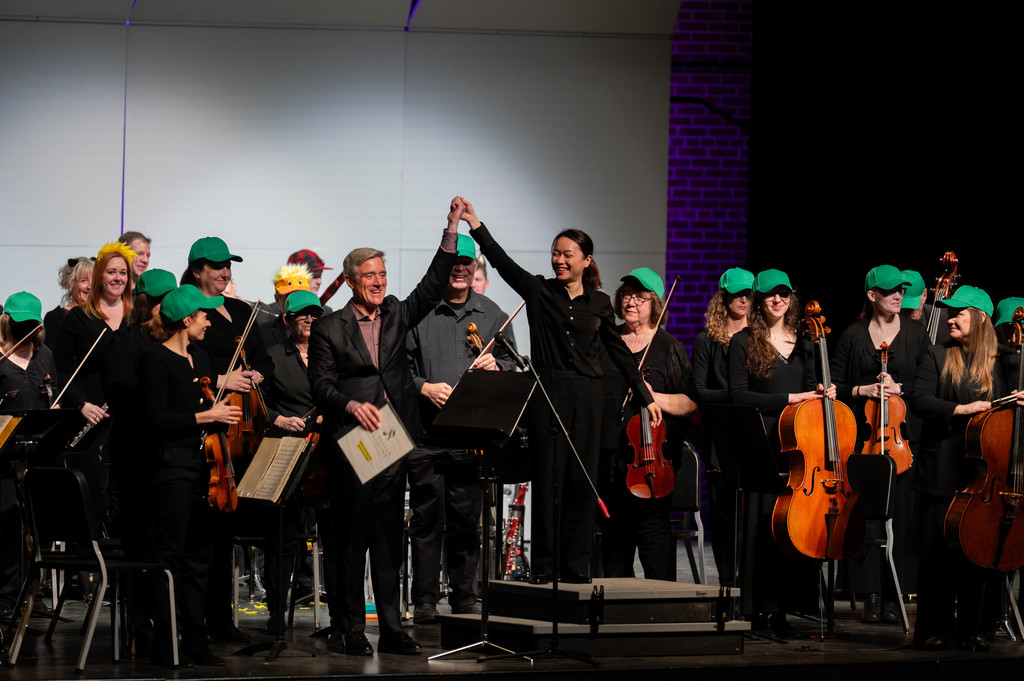 Superintendent Pekel and orchestra standing for applause