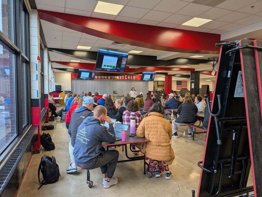At John Adams, staff participate in Curriculum and Development Day in the cafeteria.