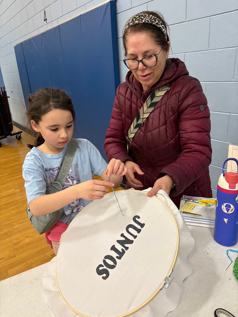 Family sewing on a community project
