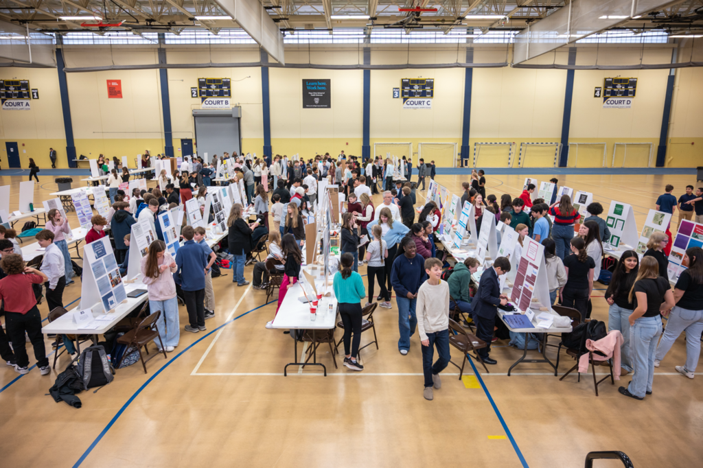 Aerial view of all the presentation boards being visited by judges and students alike in the RCTC gym.