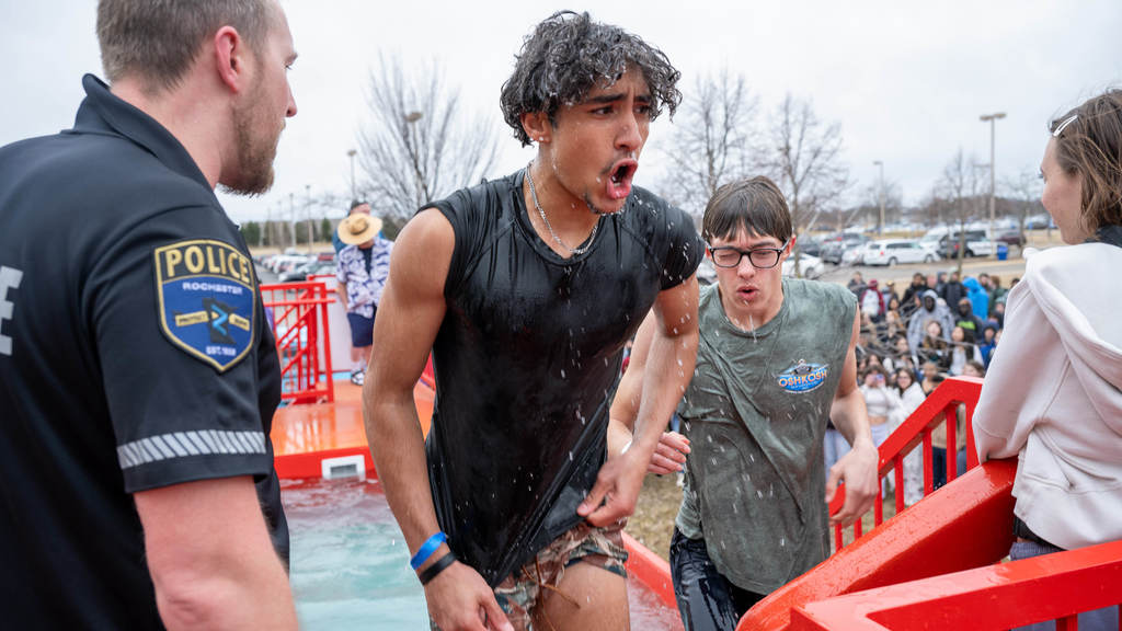 Two high school boys look shook at they find their feet after plunging into the Polar Plunge tank.