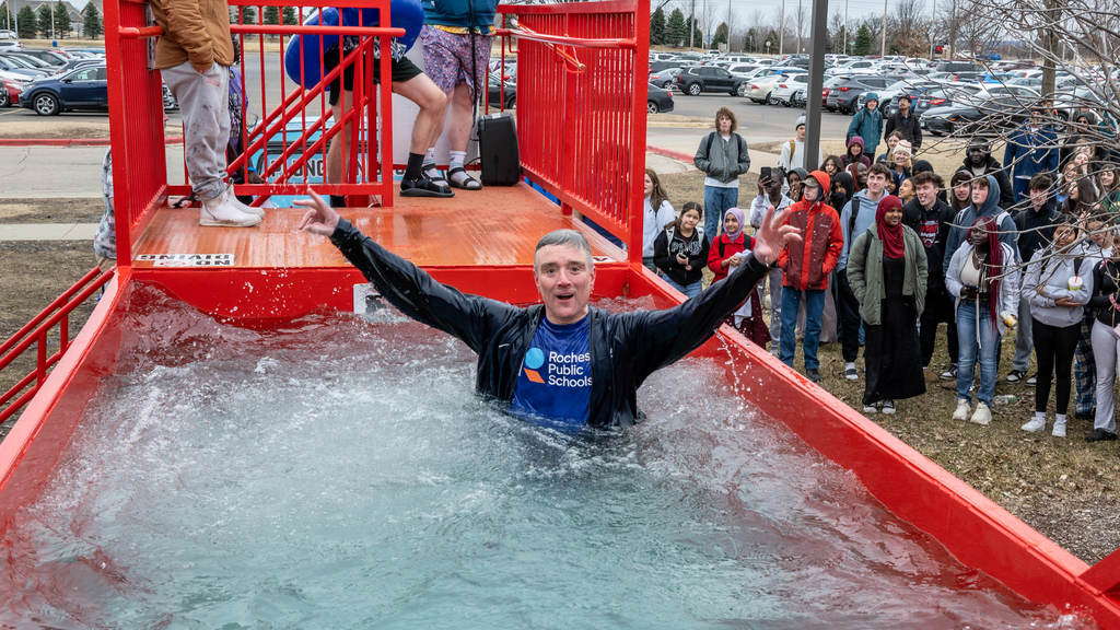 Superintendent Kent Pekel raises his arms in victory after taking the Polar Plunge.