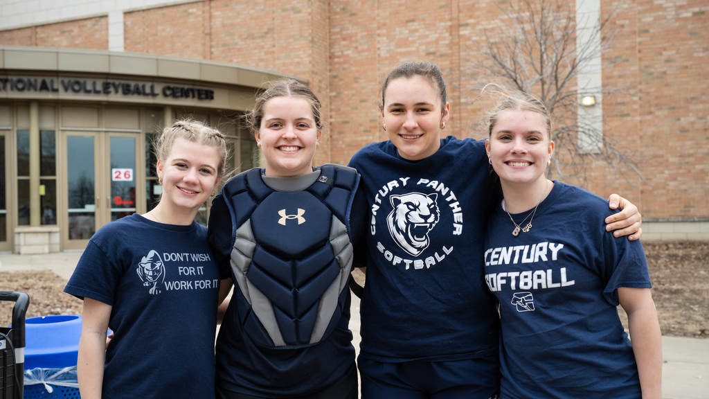 Four Century girls softball players pose arm in arm. They pump each other up before plunging into the Polar Plunge.
