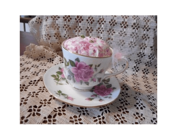 Pink rose tea cup turned into a pincushion.
