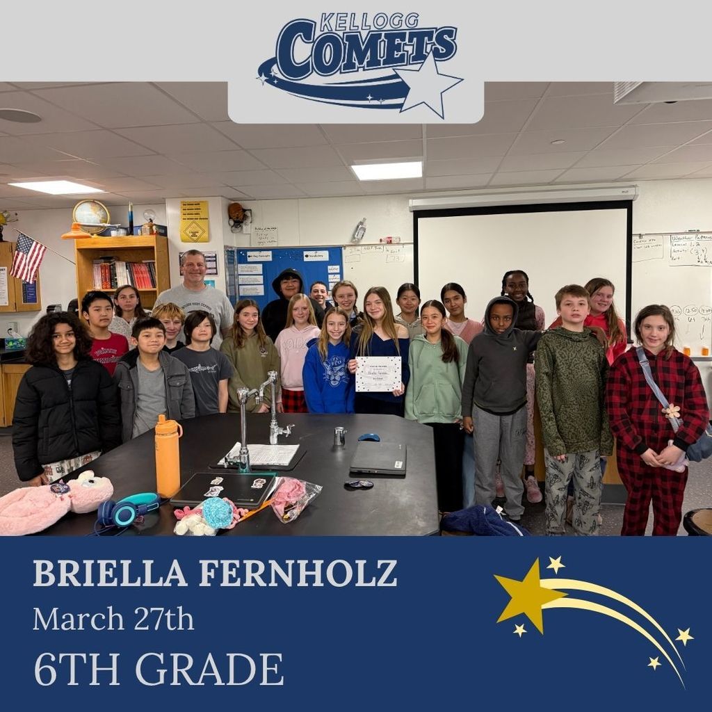 Group of students in multicolored clothing standing and smiling for a student who received award